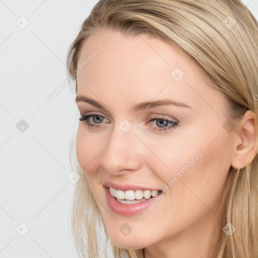 Joyful white young-adult female with long  brown hair and blue eyes