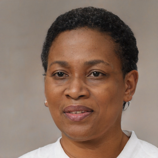 Joyful black adult female with short  black hair and brown eyes