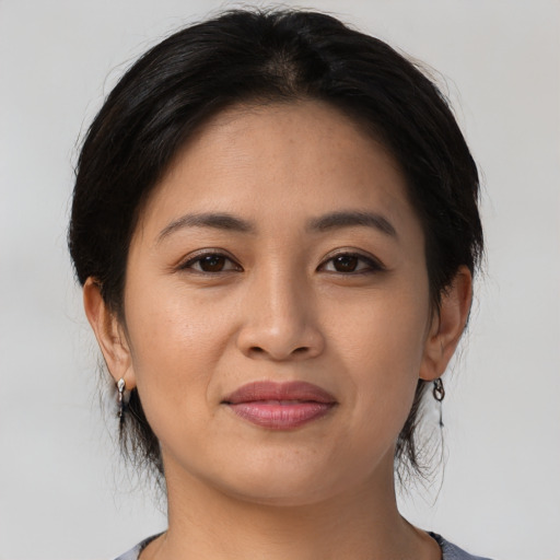 Joyful asian young-adult female with medium  brown hair and brown eyes