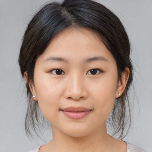 Joyful asian young-adult female with medium  brown hair and brown eyes