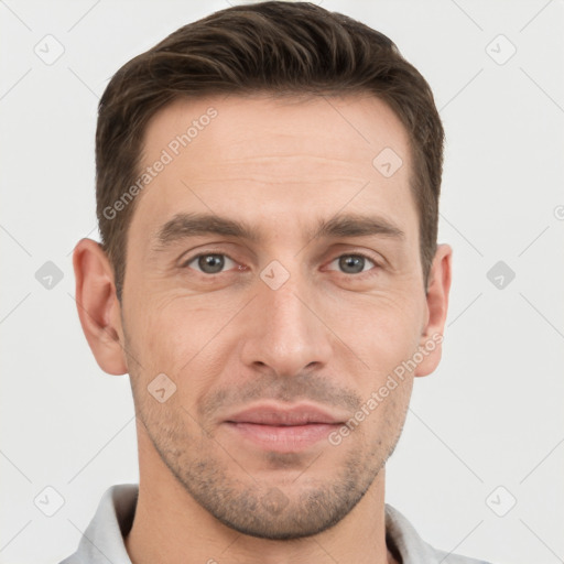 Joyful white young-adult male with short  brown hair and grey eyes