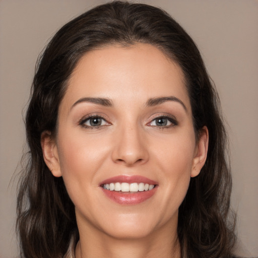 Joyful white young-adult female with long  brown hair and brown eyes