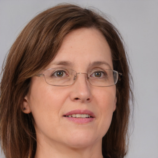 Joyful white adult female with medium  brown hair and blue eyes