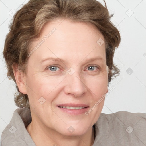 Joyful white adult female with medium  brown hair and blue eyes