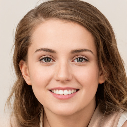 Joyful white young-adult female with long  brown hair and green eyes