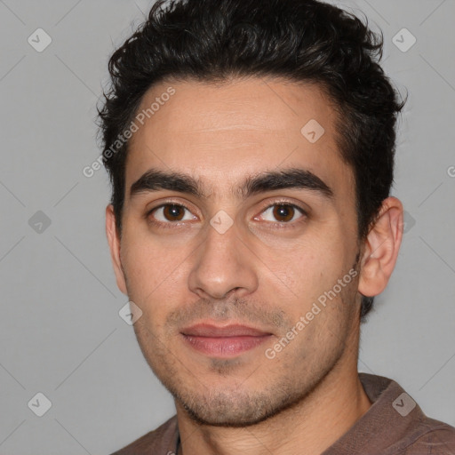 Joyful white young-adult male with short  black hair and brown eyes