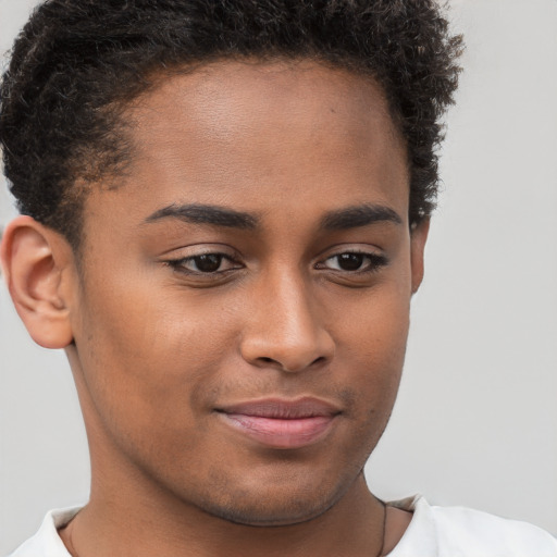 Joyful black young-adult male with short  brown hair and brown eyes