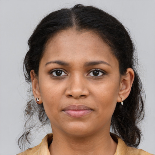 Joyful black young-adult female with medium  brown hair and brown eyes