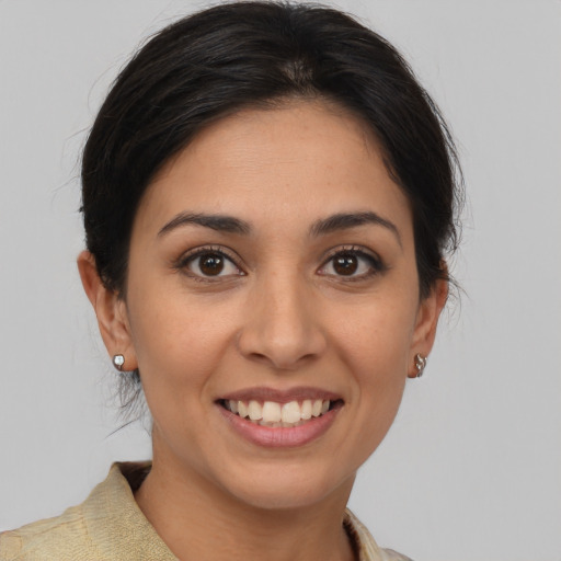 Joyful latino young-adult female with medium  brown hair and brown eyes