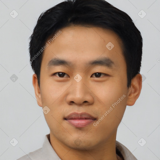 Joyful asian young-adult male with short  black hair and brown eyes