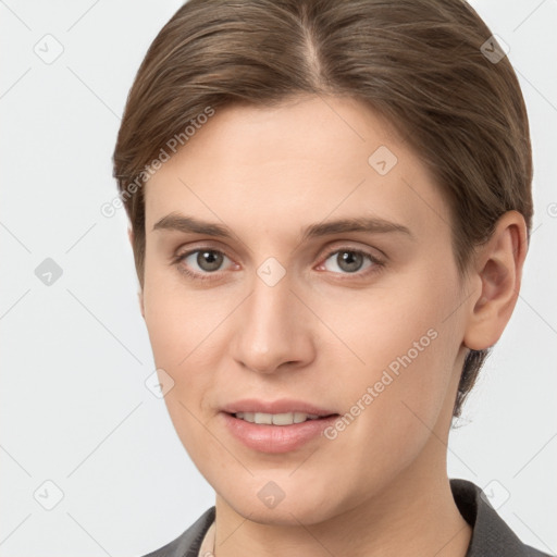 Joyful white young-adult female with short  brown hair and grey eyes