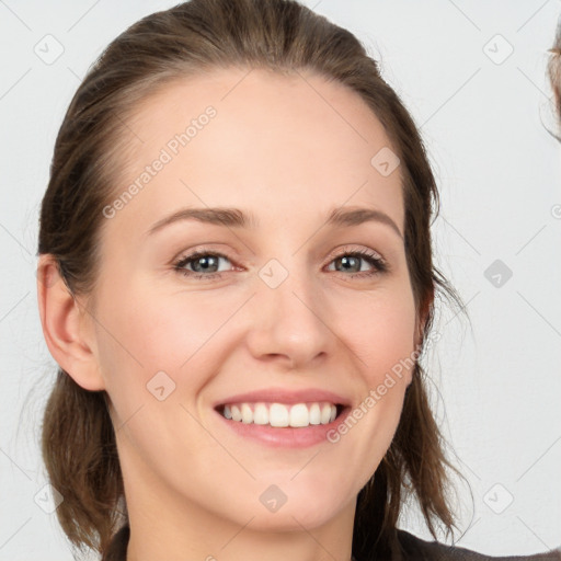 Joyful white young-adult female with medium  brown hair and grey eyes