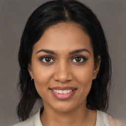 Joyful black young-adult female with medium  brown hair and brown eyes