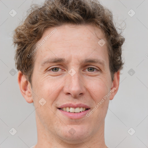 Joyful white adult male with short  brown hair and grey eyes