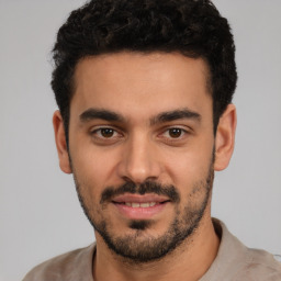 Joyful white young-adult male with short  black hair and brown eyes