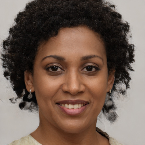 Joyful black young-adult female with short  brown hair and brown eyes