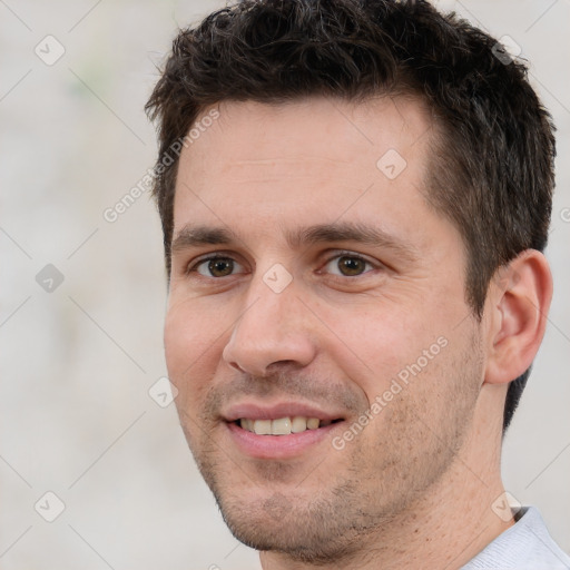 Joyful white adult male with short  brown hair and brown eyes