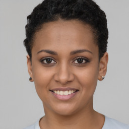 Joyful latino young-adult female with short  brown hair and brown eyes