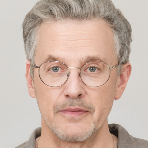 Neutral white middle-aged male with short  gray hair and blue eyes