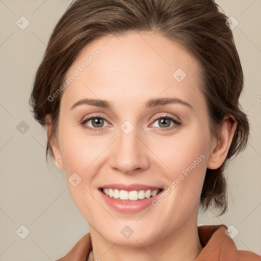 Joyful white young-adult female with medium  brown hair and green eyes