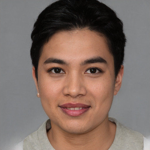 Joyful asian young-adult male with short  black hair and brown eyes