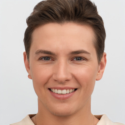 Joyful white young-adult male with short  brown hair and brown eyes