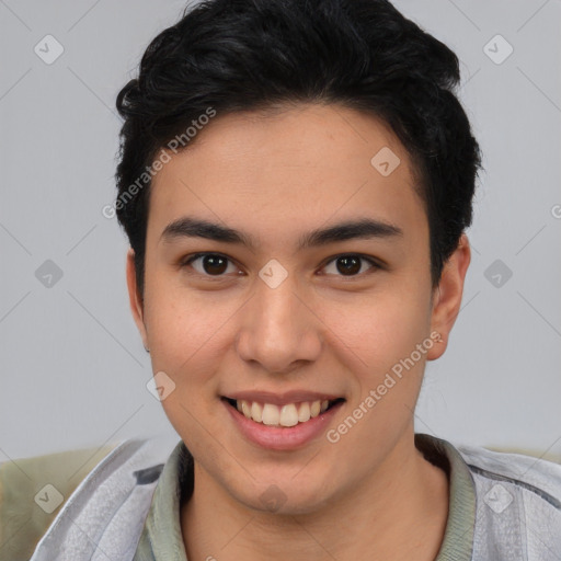 Joyful latino young-adult male with short  brown hair and brown eyes