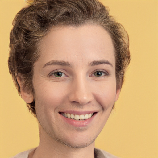 Joyful white young-adult female with short  brown hair and green eyes