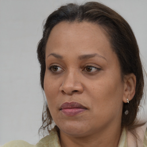 Joyful white adult female with medium  brown hair and brown eyes