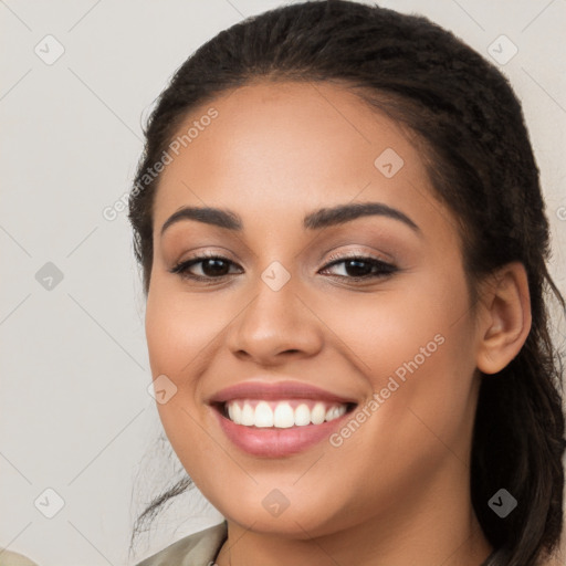 Joyful latino young-adult female with long  brown hair and brown eyes