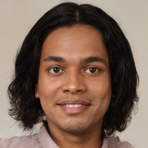 Joyful black young-adult male with medium  brown hair and brown eyes