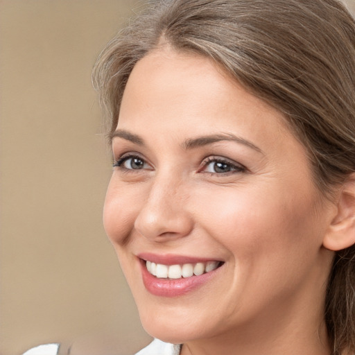 Joyful white young-adult female with medium  brown hair and brown eyes