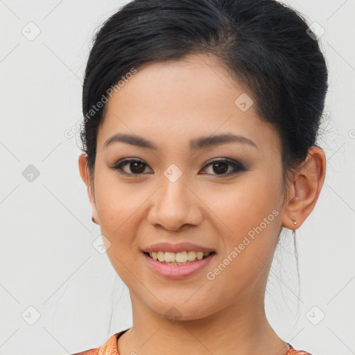 Joyful latino young-adult female with medium  brown hair and brown eyes