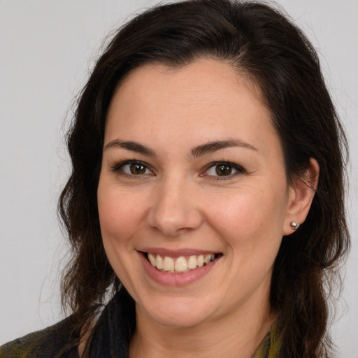 Joyful white young-adult female with long  brown hair and brown eyes