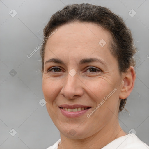 Joyful white adult female with short  brown hair and brown eyes