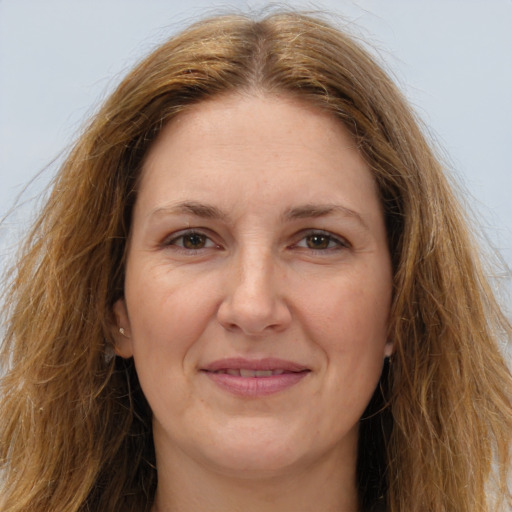 Joyful white adult female with long  brown hair and brown eyes