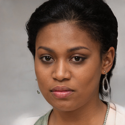 Neutral black young-adult female with medium  brown hair and brown eyes