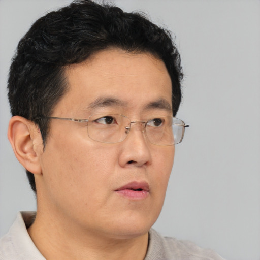 Neutral asian adult male with short  brown hair and brown eyes