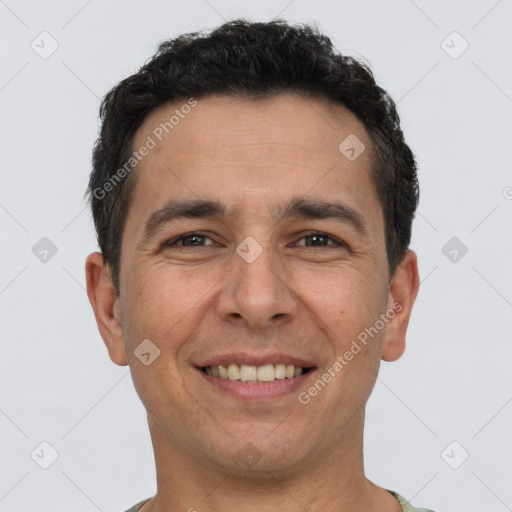 Joyful white adult male with short  black hair and brown eyes