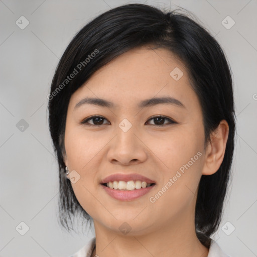 Joyful asian young-adult female with medium  black hair and brown eyes