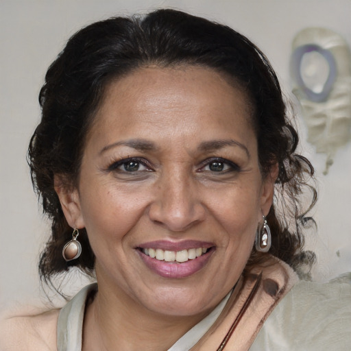 Joyful latino adult female with medium  brown hair and brown eyes