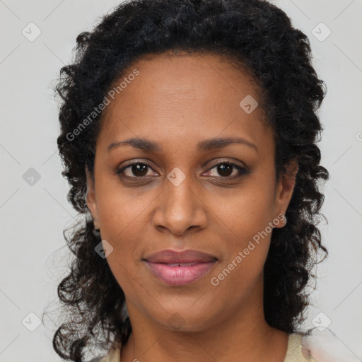 Joyful black young-adult female with long  brown hair and brown eyes