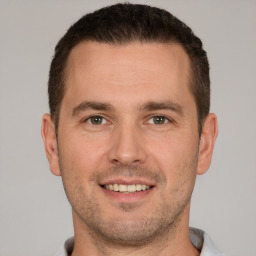 Joyful white young-adult male with short  brown hair and brown eyes