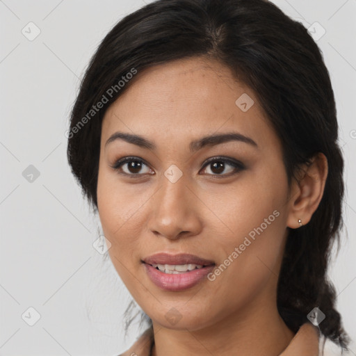 Joyful latino young-adult female with medium  brown hair and brown eyes