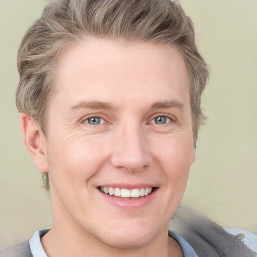 Joyful white adult male with short  brown hair and grey eyes