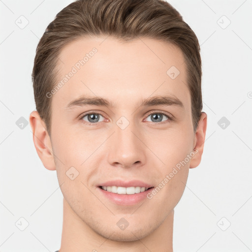 Joyful white young-adult male with short  brown hair and grey eyes