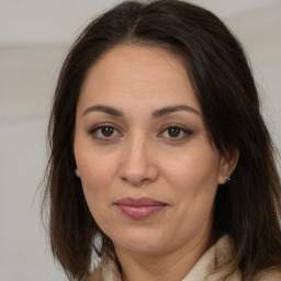 Joyful white adult female with long  brown hair and brown eyes