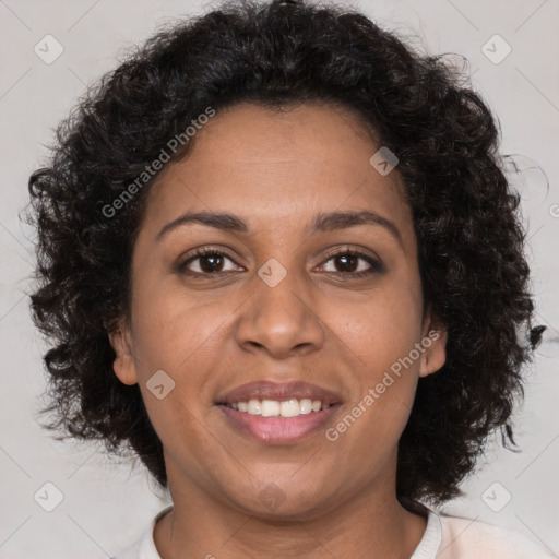 Joyful black adult female with medium  brown hair and brown eyes