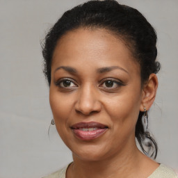 Joyful black young-adult female with medium  brown hair and brown eyes