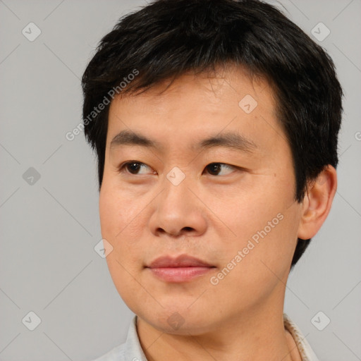 Joyful asian young-adult male with short  brown hair and brown eyes